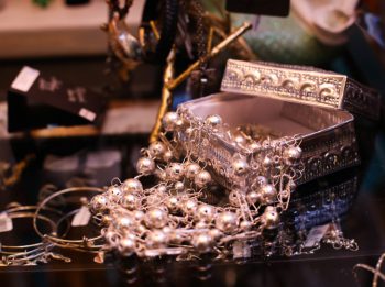 Silver strung bracelets and necklaces displayed with a silver gift box